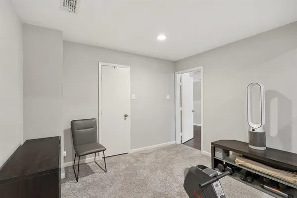 a room with a chair and gym equipment