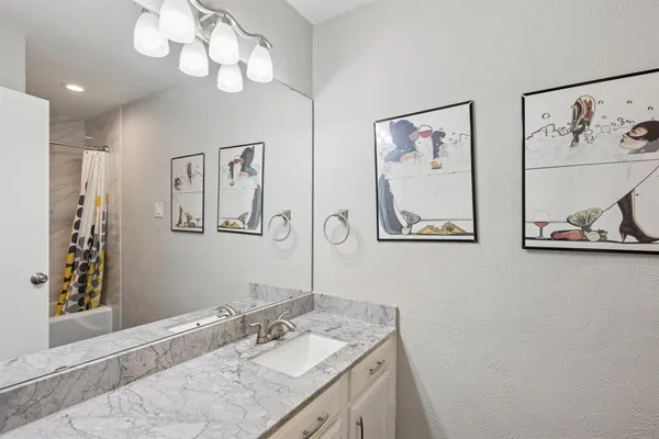 a bathroom with double vanity sink and a mirror