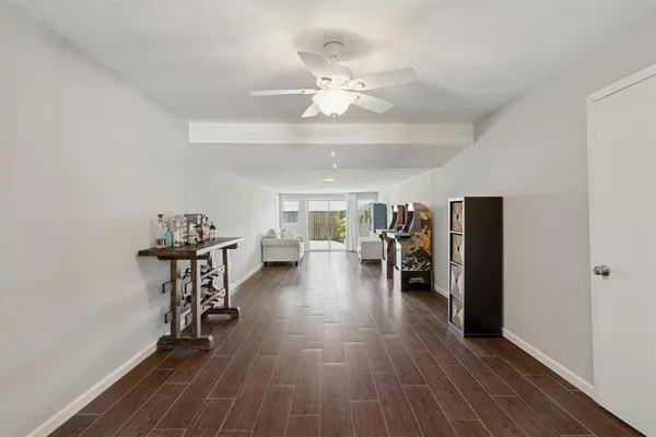 a view of a room with furniture and wooden floor