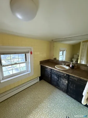 a bedroom with a bed couch and a desk