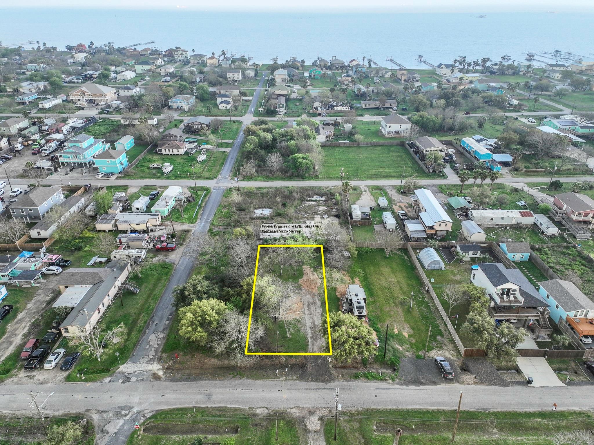 an aerial view of residential houses with outdoor space and street view