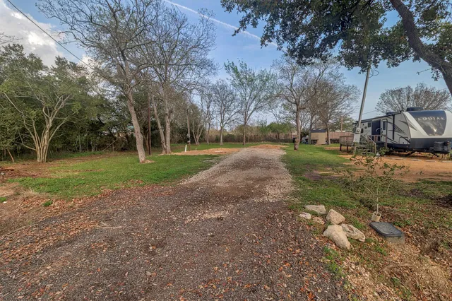 a view of a tree in front of a house