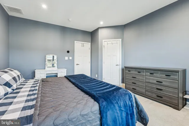 a bedroom with a bed and a dresser