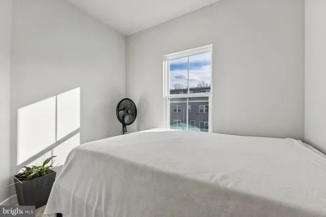 a bedroom with a bed and a window