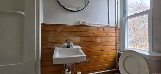 a bathroom with a sink a mirror and bathtub