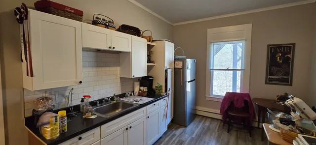 a kitchen with a sink appliances and cabinets