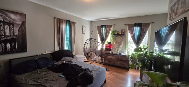 a living room with furniture wooden floor and a flat screen tv