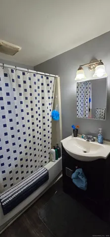 a bathroom with a sink a mirror and a shower
