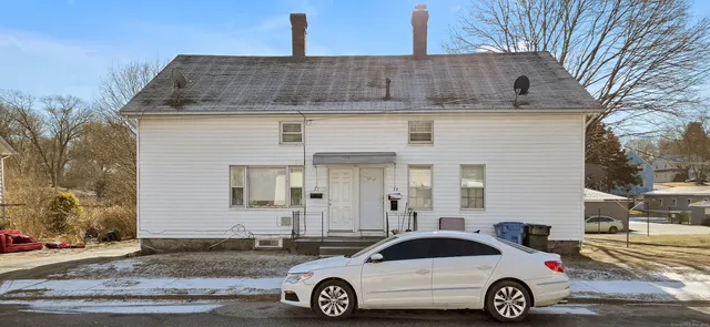 a front view of a house with parking space