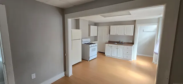a kitchen with white cabinets and a sink