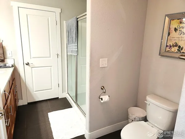 a bathroom with a toilet and a shower