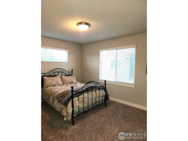 a bed sitting in a room next to a window