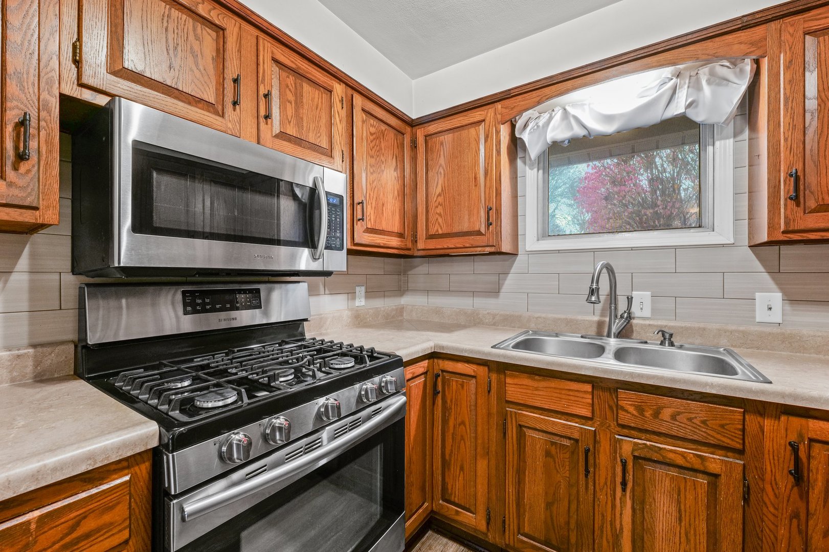 911 South Longview Road Monticello, IL 61856 - Photo 12 of 28 a kitchen with stainless steel appliances a stove a sink and a microwave