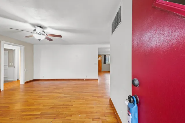 a view of a livingroom with an empty space and a ceiling fan