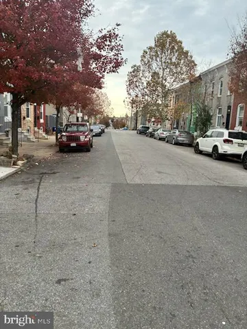 a view of street with parked cars