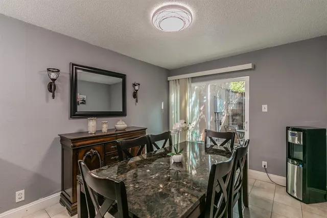 a view of a dining room with furniture and a chandelier