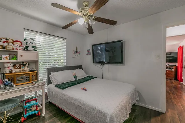 a bedroom with a bed and a flat screen tv