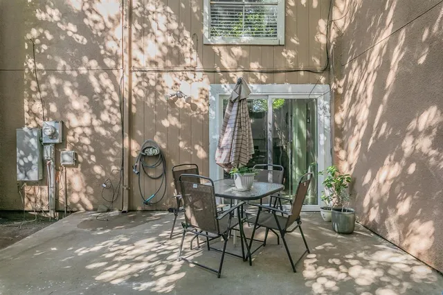 a view of a patio with table and chairs and potted plants
