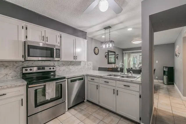 a kitchen with a sink stove and microwave