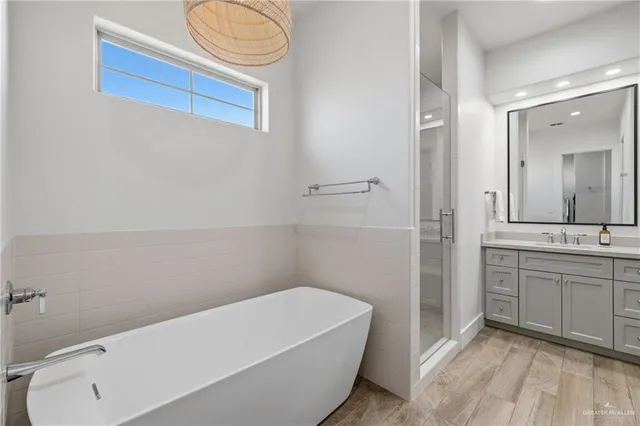 a bathroom with a tub sink and mirror