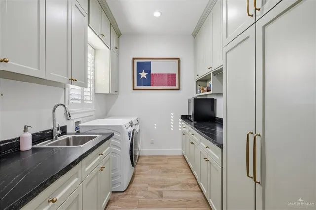 a kitchen with granite countertop a sink and a stove top oven