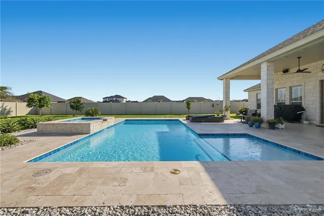a view of swimming pool with outdoor seating and plants