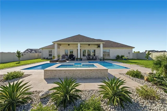 a view of a house with swimming pool and sitting area