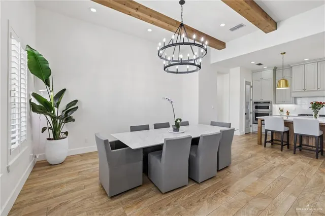 a view of a dining room with furniture wooden floor and chandelier