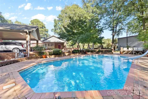 a swimming pool with outdoor seating and yard