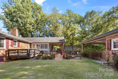 a view of a house with sitting area and a yard
