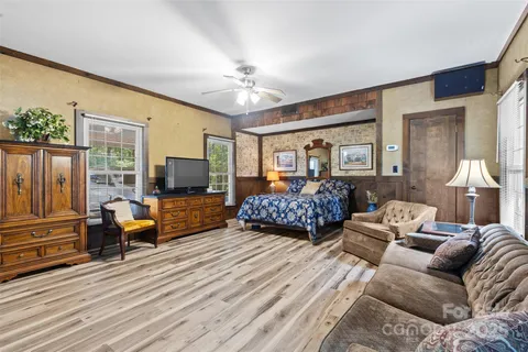 a bedroom with furniture and a large window