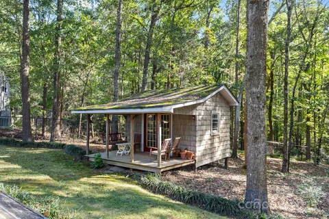 a view of a house with backyard porch and sitting area