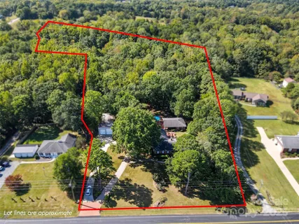 an aerial view of a houses with a yard