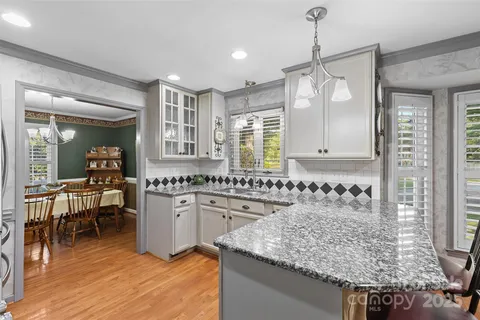 a kitchen with lots of counter space and windows