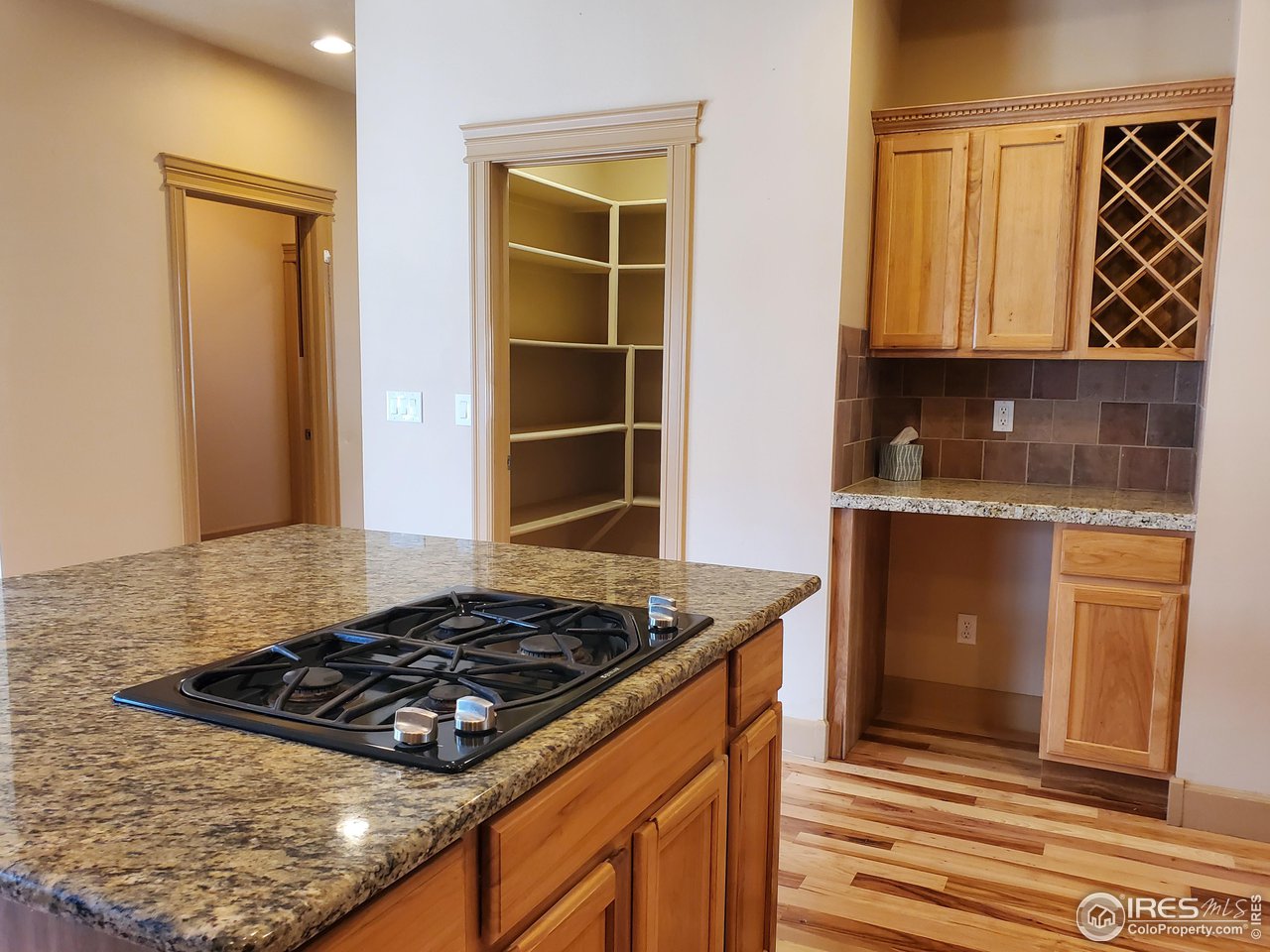 6541 West 18th Street Road Greeley, CO 80634 - Photo 13 of 40 a kitchen with a stove and a refrigerator