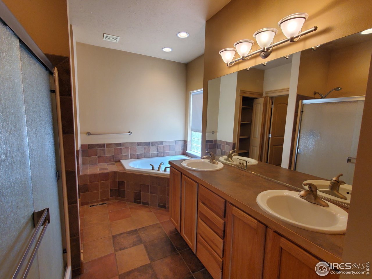 6541 West 18th Street Road Greeley, CO 80634 - Photo 21 of 40 a bathroom with a sink double vanity and a mirror