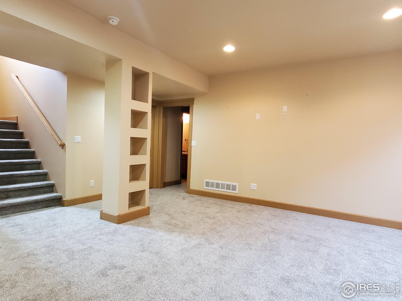 6541 West 18th Street Road Greeley, CO 80634 - Photo 28 of 40 an empty room with wooden floor and stairs