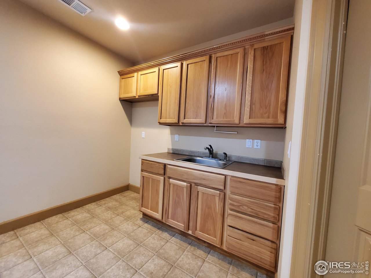 6541 West 18th Street Road Greeley, CO 80634 - Photo 30 of 40 a kitchen with a sink and cabinets