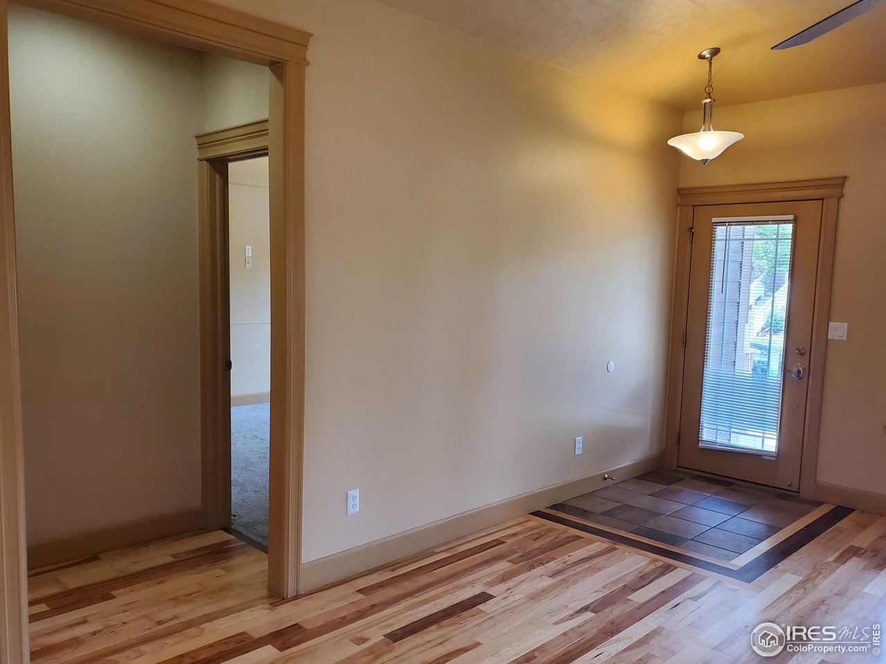6541 West 18th Street Road Greeley, CO 80634 - Photo 9 of 40 a view of an empty room with wooden floor and a window