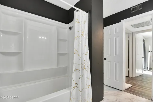 a bathroom with a bathtub and a shower