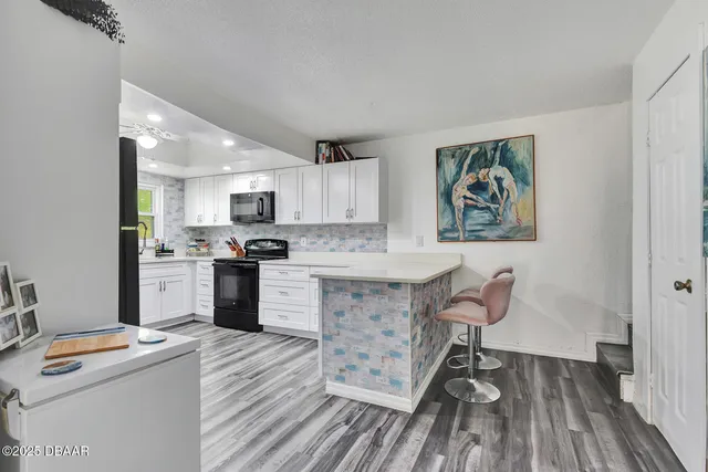 a kitchen with granite countertop stainless steel appliances a sink and counter space