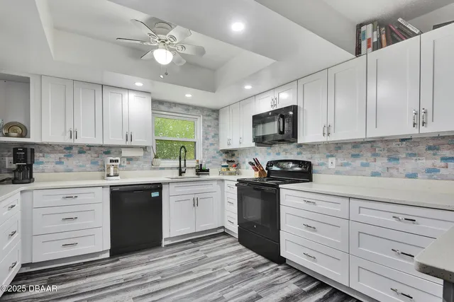 a kitchen with granite countertop a stove sink and cabinets