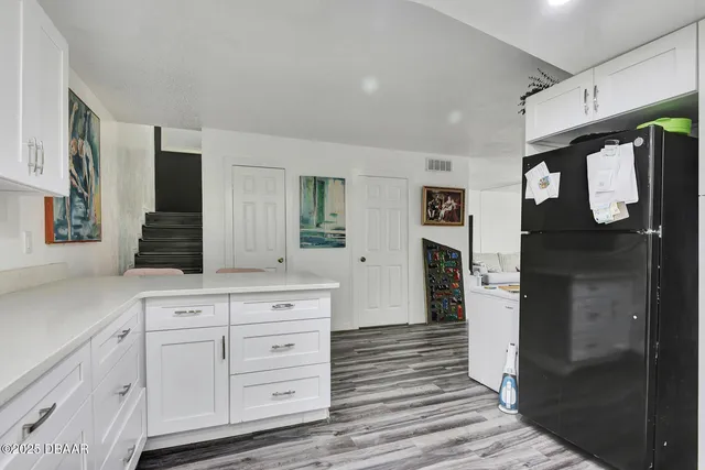a spacious bathroom with a granite countertop sink and a mirror