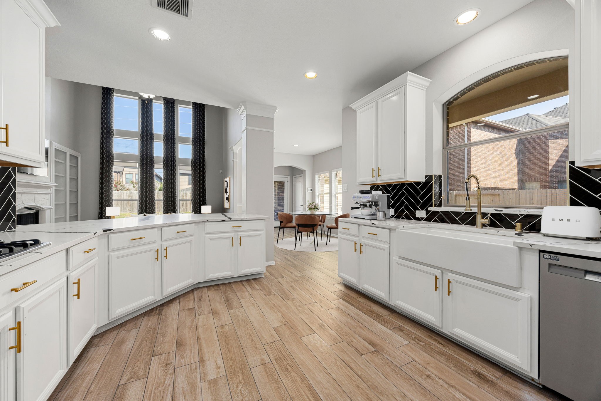 3407 Cardiff Mist Drive Katy, TX 77494 - Photo 10 of 28 Additional view of the kitchen showcasing the large farmhouse sink and gorgeous window overlooking the outdoor Patio! *Virtually staged