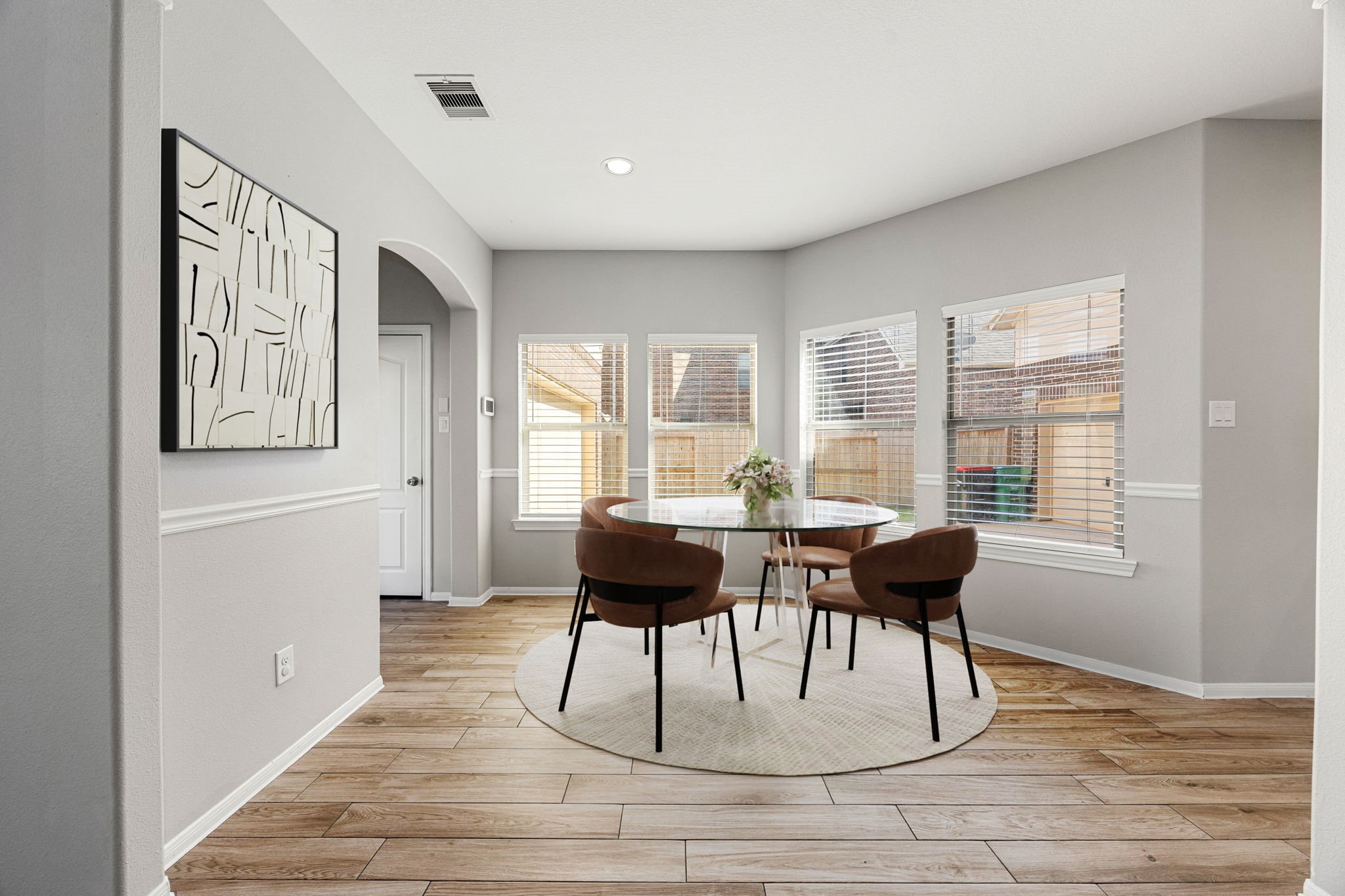 3407 Cardiff Mist Drive Katy, TX 77494 - Photo 11 of 28 This lovely breakfast area is perfect for starting the day out on the right foot. This space showcases custom paint, high ceilings, recessed lighting, large windows with blinds adding to the ample natural light in the kitchen, beautiful chair rail molding and gorgeous wood look tile flooring. *Virtually staged