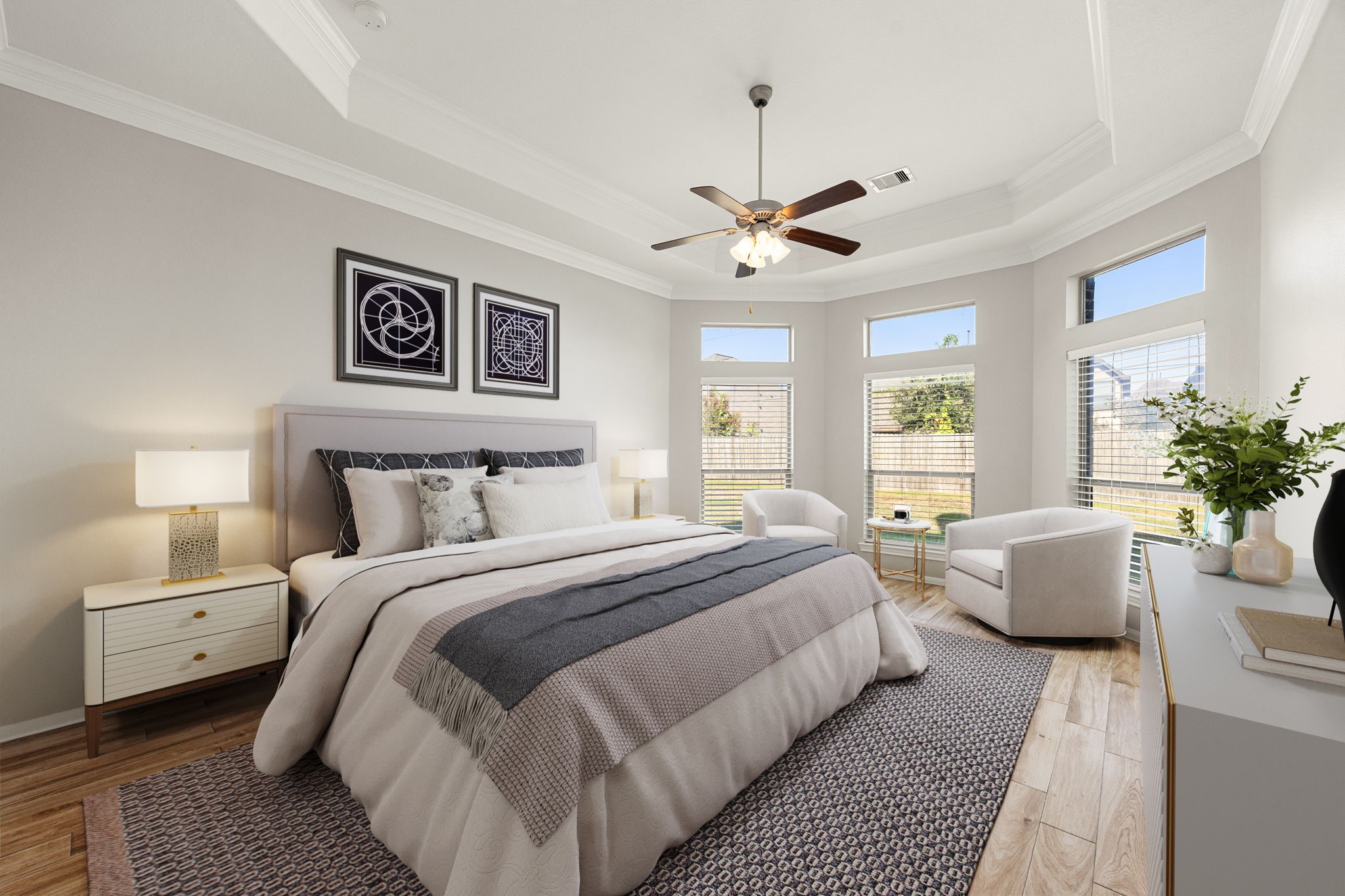 3407 Cardiff Mist Drive Katy, TX 77494 - Photo 13 of 28 What a wonderful place to come home to, this stunning primary suite greets you with gorgeous wood look tile flooring, a neutral custom paint, high ceiling, crown molding, ceiling fan with lighting, lovely windows with blinds allowing in natural light brightening up this spacious primary bedroom, with extra space for a seating area.