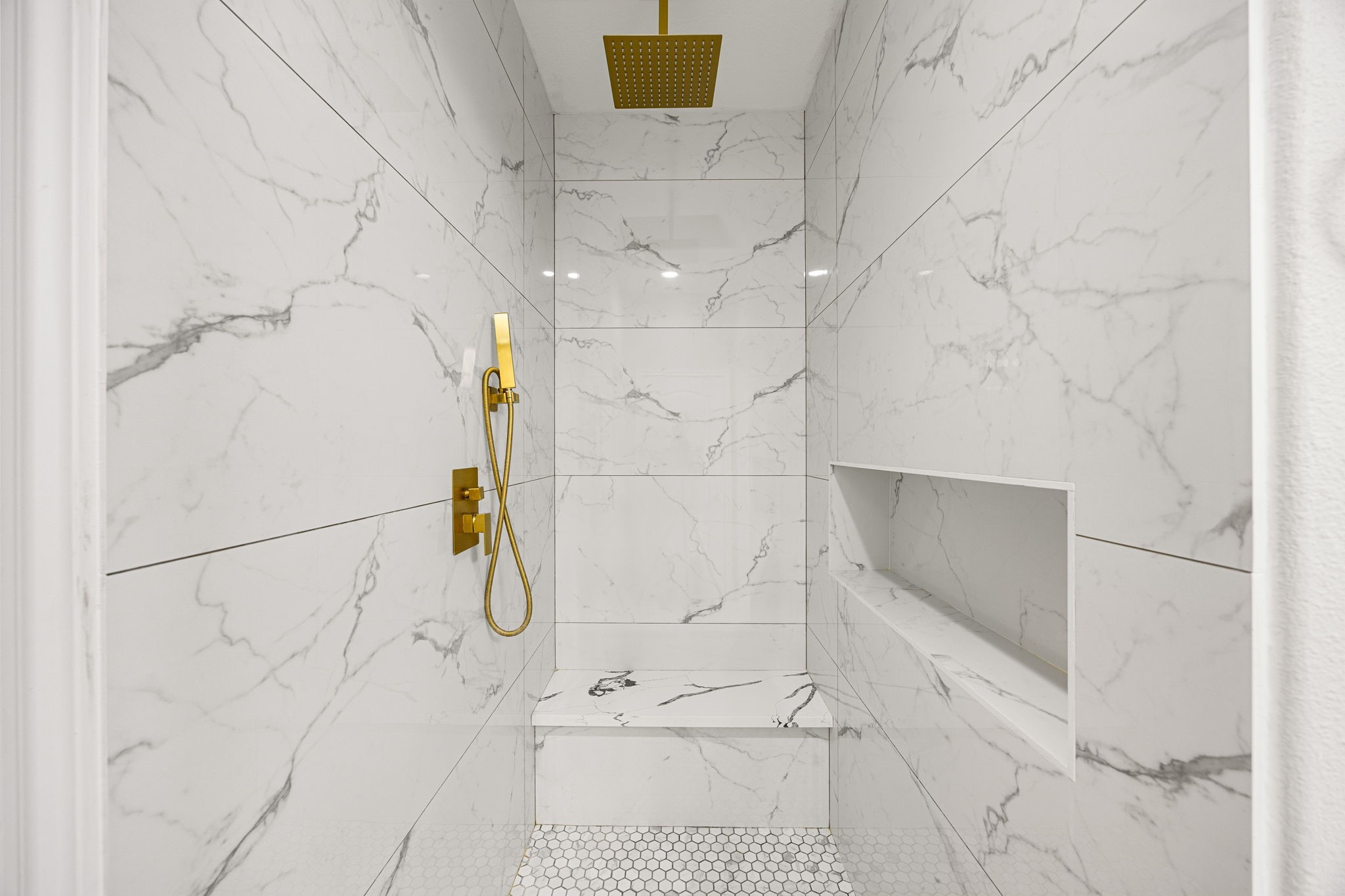 3407 Cardiff Mist Drive Katy, TX 77494 - Photo 15 of 28 This additional view of the primary bath showcases the walk-in shower with tile surround, seat and modern sleek finishes.