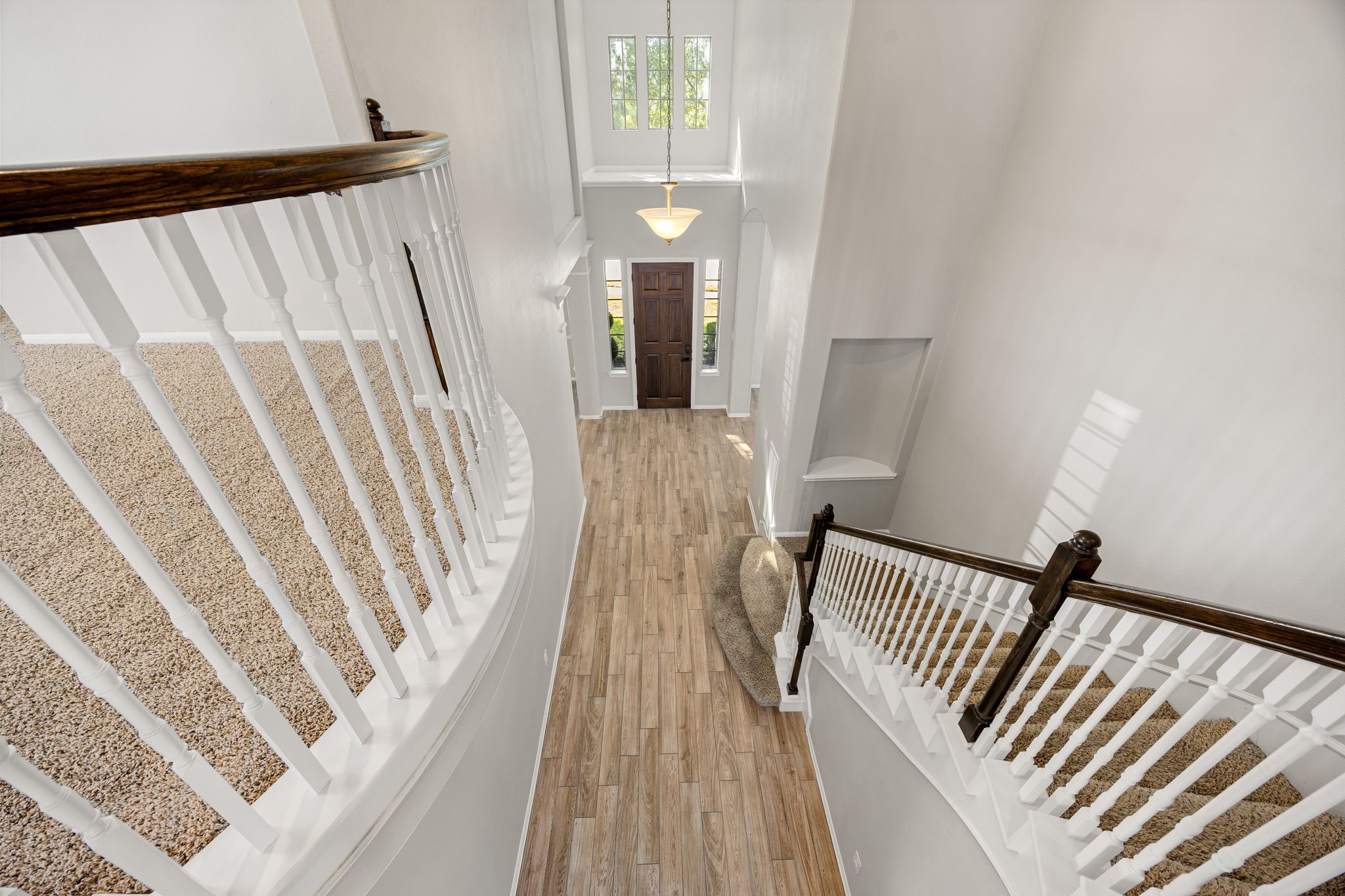 3407 Cardiff Mist Drive Katy, TX 77494 - Photo 4 of 28 This stunning view of the entryway highlights the soaring ceilings, elegant chandelier, and the beautifully crafted staircase with detailed railing and spindles—truly a spectacular and refined welcome!