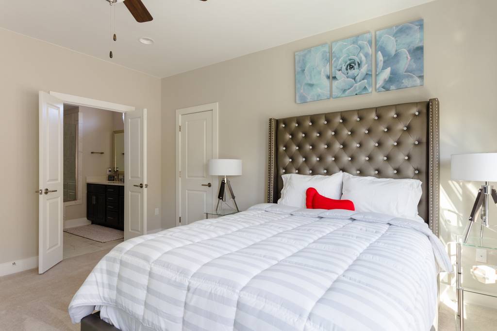 807 East 16th Street, Unit A Austin, TX 78702 - Photo 16 of 29 a bedroom with a bed and a lamp