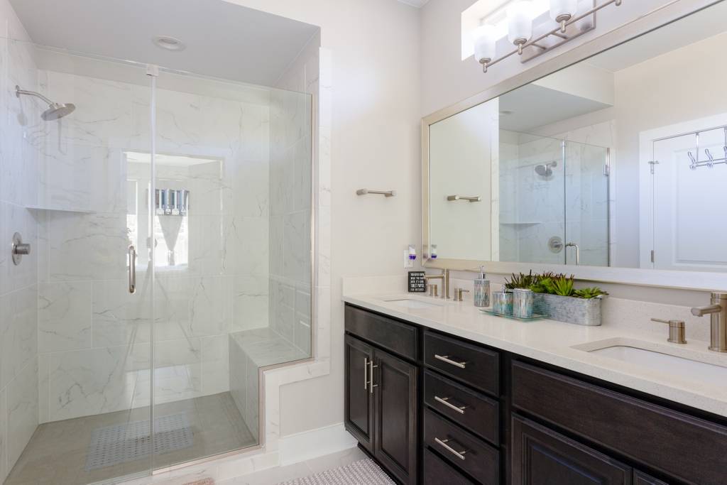 807 East 16th Street, Unit A Austin, TX 78702 - Photo 19 of 29 a bathroom with a sink double vanity granite tub and a mirror